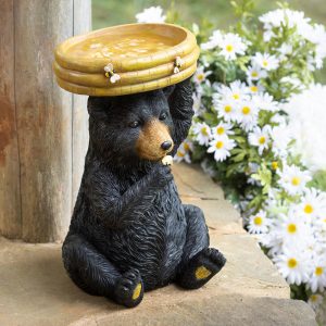 Add a whimsical accent to any outdoor space while giving birds a place to take a quick bath with this charming bear resin bird bath. With carved details, the cheery bear holds up a bowl shaped as a beehive. Crafted from durable polyresin with fade-resistant colors, this design is completely outdoor safe and weather-resistant to ensure it stays vibrant season after season. Holding approximately 48 oz, it can also be used as a bird feeder.