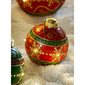 This 8" Battery Operated Outdoor Christmas Ornament looks fantastic on its own or incorporate with your other outdoor decor. The ornament is red trimmed in green with accents of gold snowflakes and more.